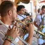 male band playing brass wind instrument outdoors