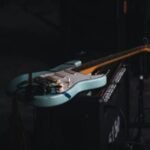 teal and brown electric guitar