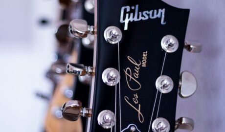 shallow focus photography black Gibson guitar headstock