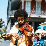 A man playing the violin or fiddle on the streets in New Orleans in the French Quarter