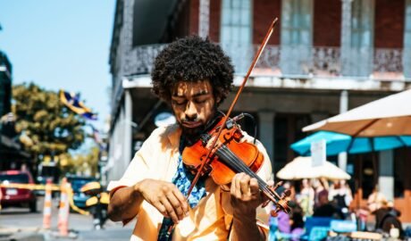 A man playing the violin or fiddle on the streets in New Orleans in the French Quarter