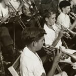 grayscale photography of group of people playing instruments