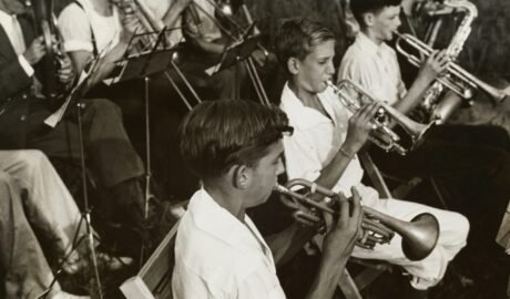 grayscale photography of group of people playing instruments