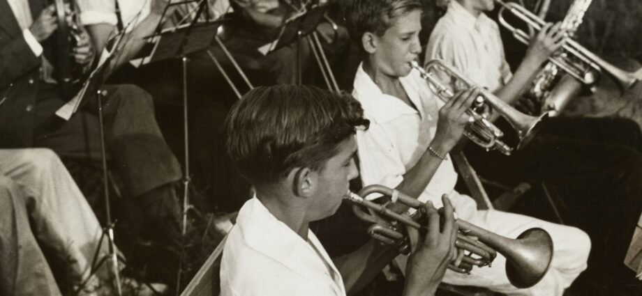 grayscale photography of group of people playing instruments